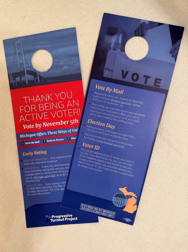 A photo showing the front and back of a door hanger with instructions for how to vote in Michigan